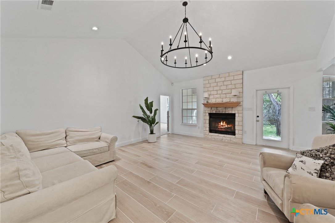 Chandelier, Fireplace, Interior, Living room, Pendant Lights, Recessed Lighting, Wood Texture Flooring