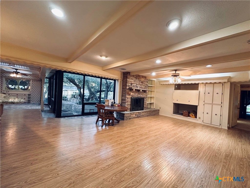 Dining room, Fireplace, Interior, Recessed Lighting, Stone Walls, Wood Texture Flooring