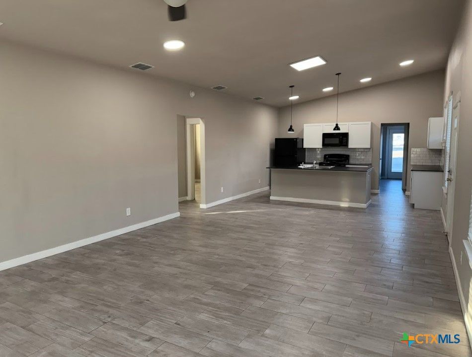 Empty room, Interior, Kitchen, Pendant Lights, Recessed Lighting, Stainless Steel Appliances, Wood Texture Flooring