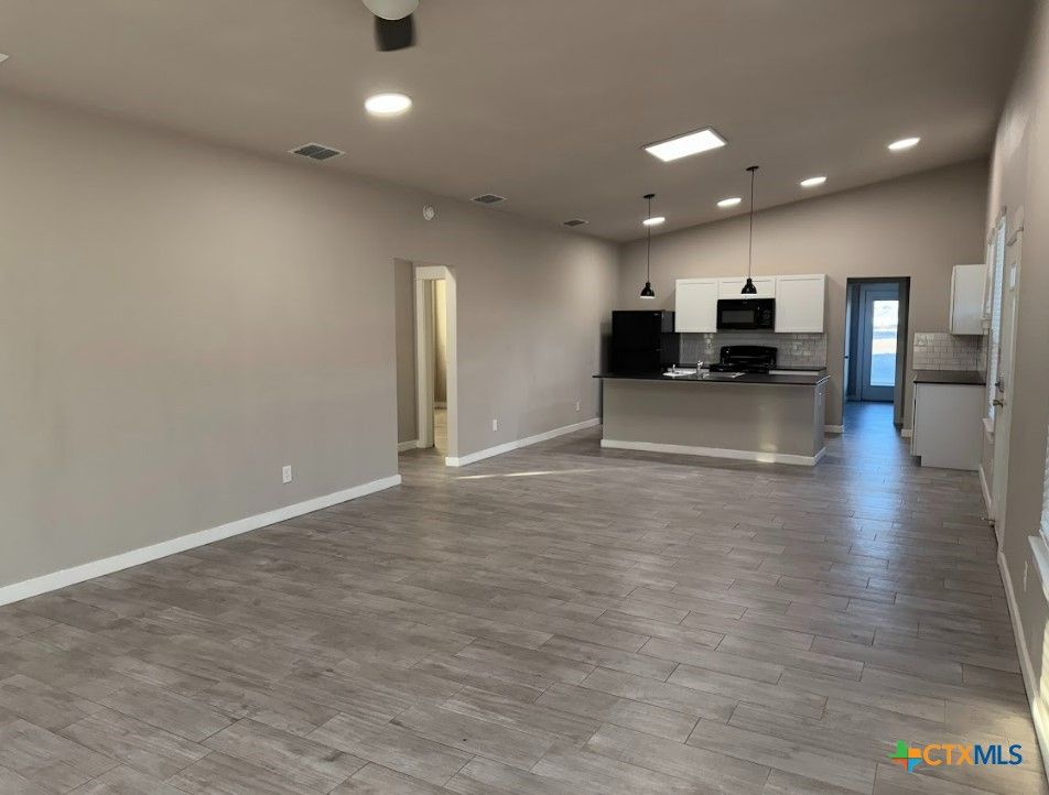 Empty room, Interior, Kitchen, Pendant Lights, Recessed Lighting, Stainless Steel Appliances, Wood Texture Flooring