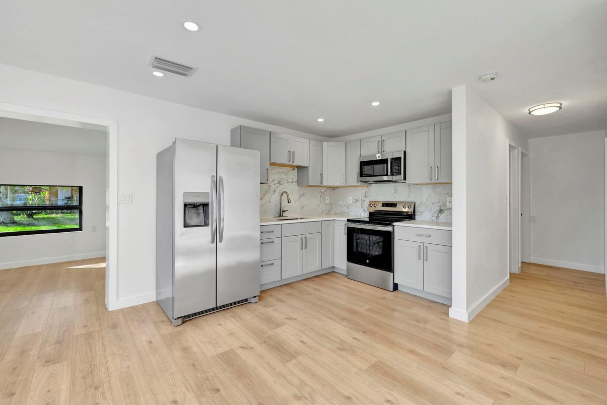 Interior, Kitchen, Marble Walls, Recessed Lighting, Stainless Steel Appliances, Wood Texture Flooring