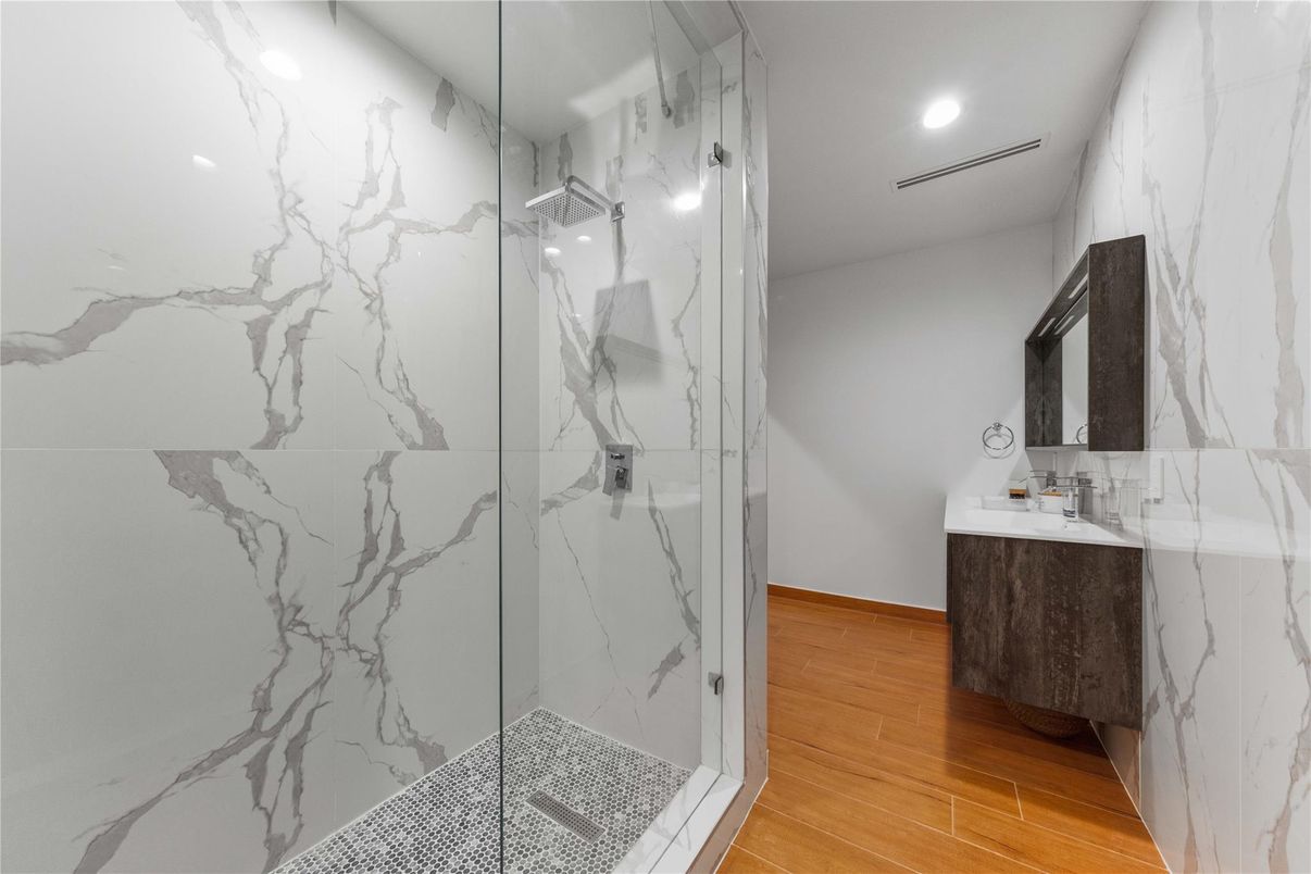 Bathroom, Glass Shower, Interior, Marble Walls, Recessed Lighting, Wood Texture Flooring