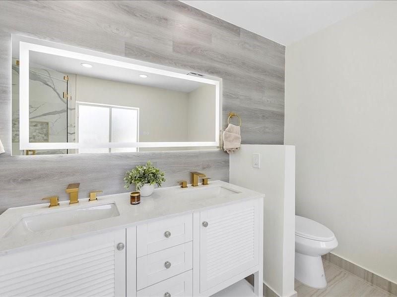 Bathroom, Dual Sink Vanities, Interior, Marble Walls, Recessed Lighting, Wood Texture Flooring