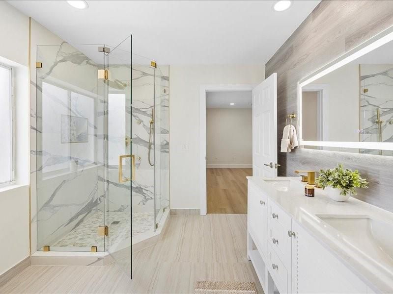 Bathroom, Dual Sink Vanities, Glass Shower, Interior, Marble Walls, Recessed Lighting, Wood Texture Flooring