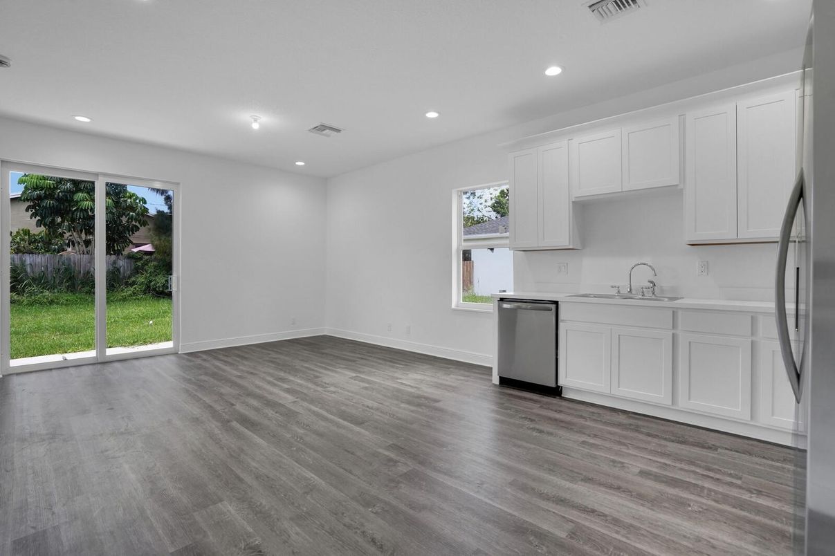 Empty room, Interior, Kitchen, Recessed Lighting, Stainless Steel Appliances, Wood Texture Flooring