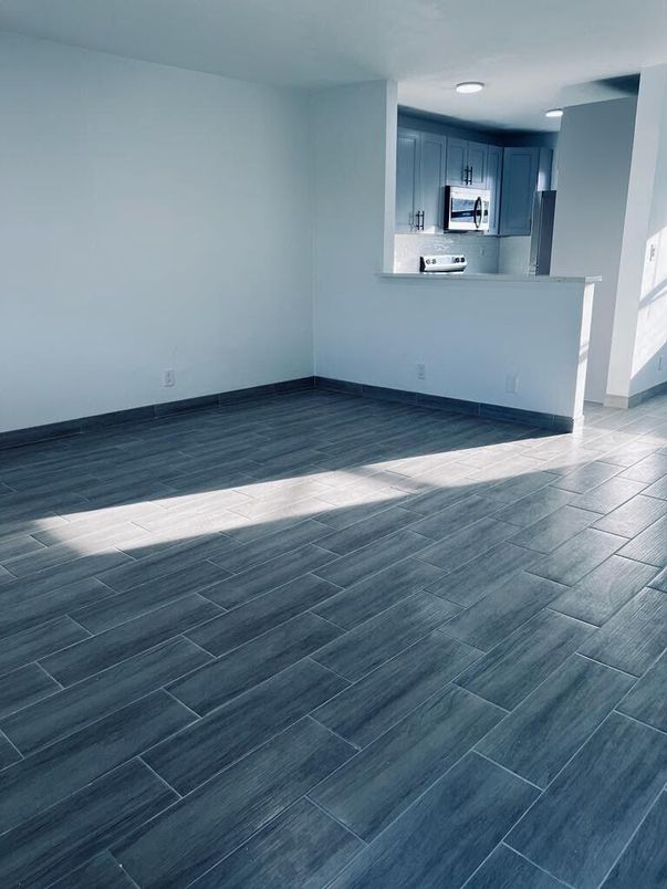 Empty room, Interior, Kitchen, Recessed Lighting, Stainless Steel Appliances, Wood Texture Flooring