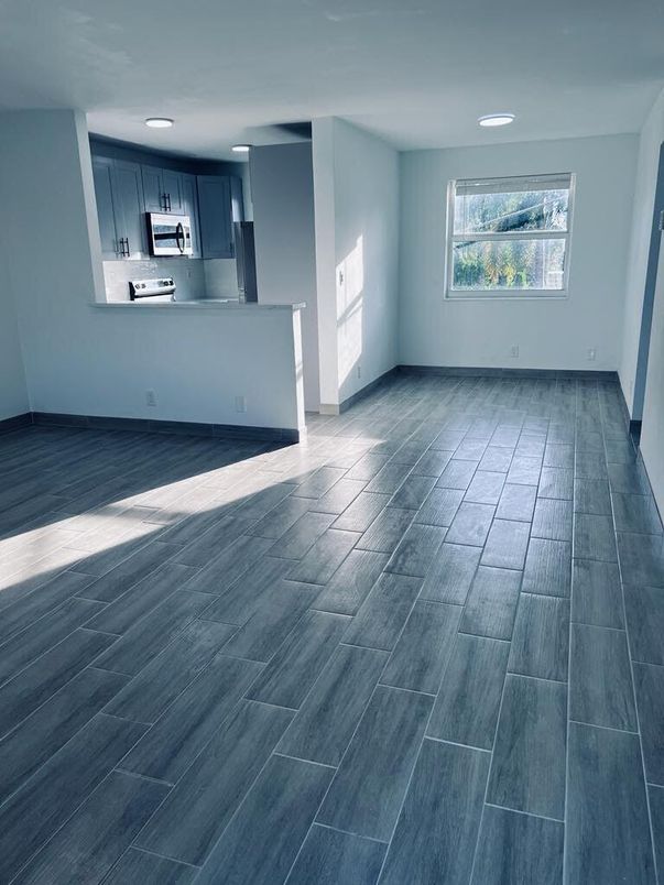 Empty room, Interior, Kitchen, Recessed Lighting, Stainless Steel Appliances, Wood Texture Flooring