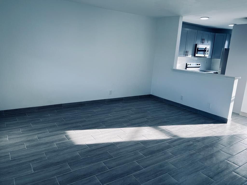 Empty room, Interior, Kitchen, Recessed Lighting, Stainless Steel Appliances, Wood Texture Flooring