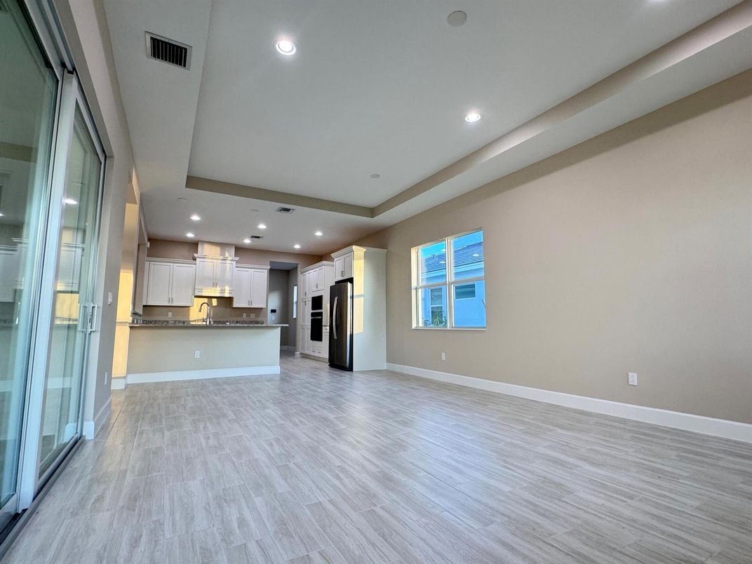 Empty room, Interior, Kitchen, Recessed Lighting, Stainless Steel Appliances, Wood Texture Flooring