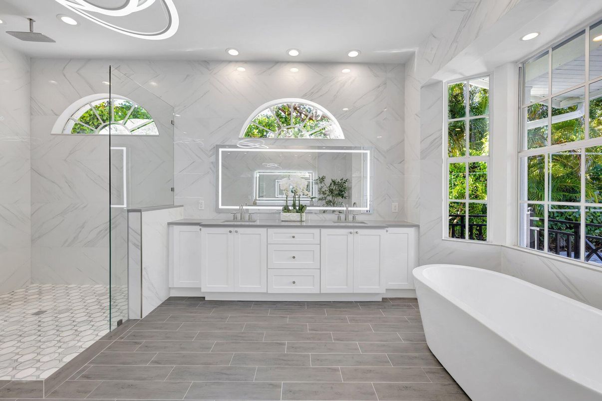 Bathroom, Dual Sink Vanities, Free Standing Baths, Glass Shower, Interior, Marble Walls, Recessed Lighting, Wood Texture Flooring