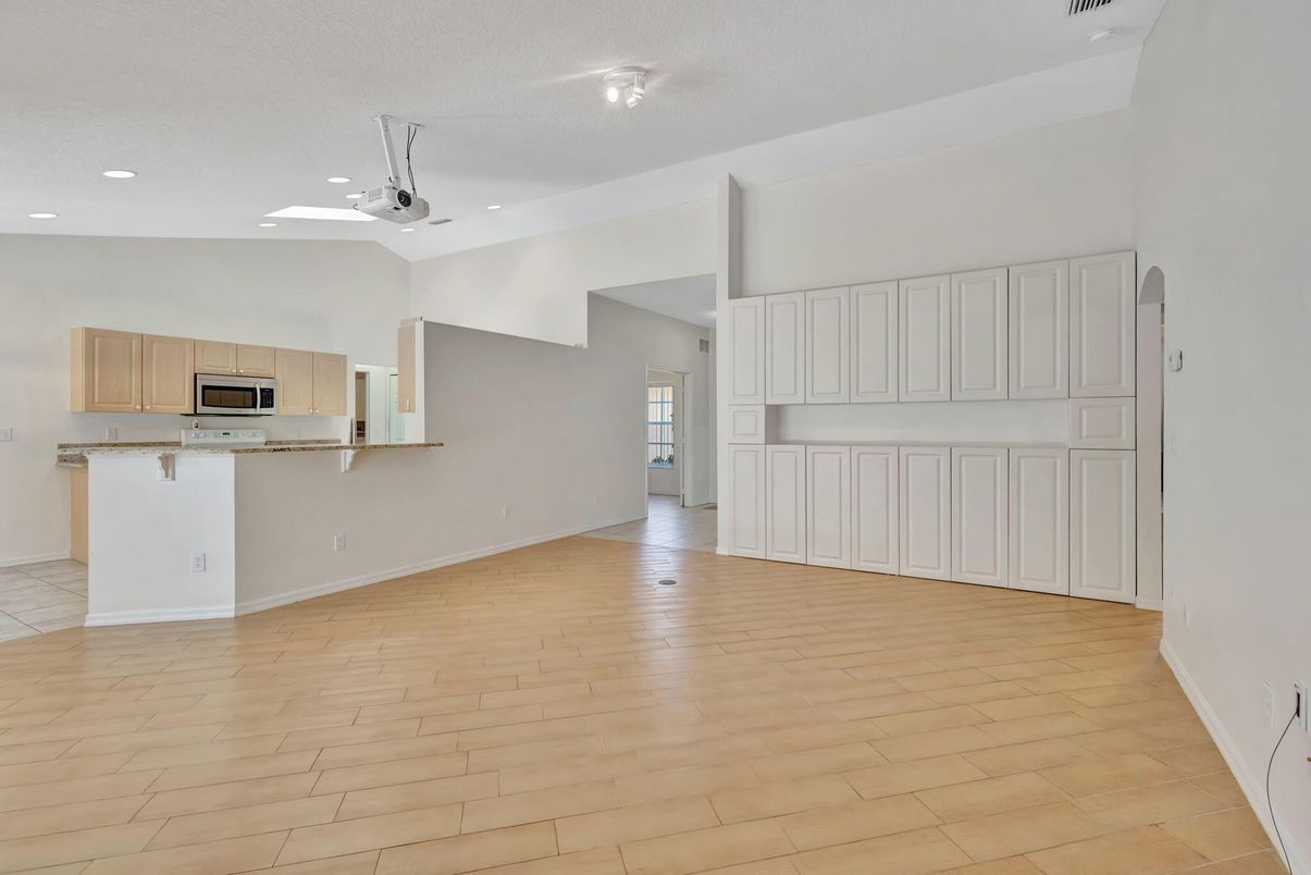 Empty room, Interior, Kitchen, Recessed Lighting, Stainless Steel Appliances, Wood Texture Flooring