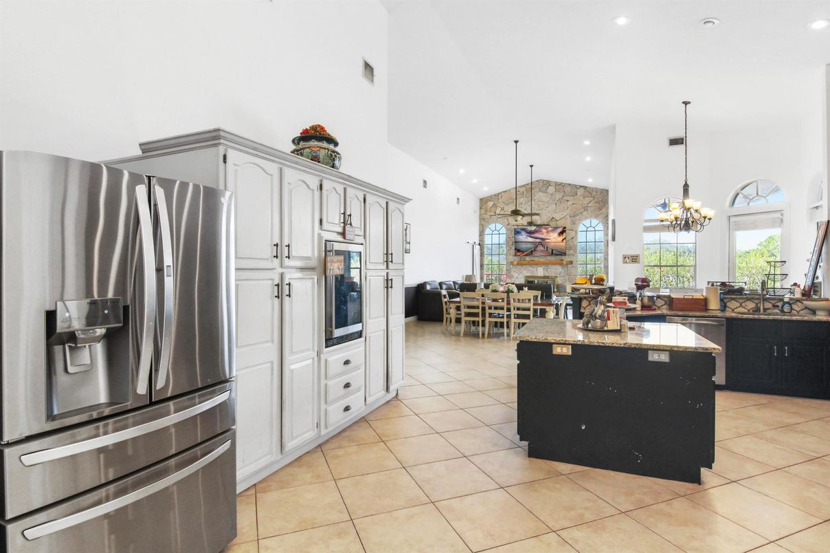 Chandelier, Dining room, Fireplace, Interior, Kitchen, Pendant Lights, Recessed Lighting, Stainless Steel Appliances, Stone Walls