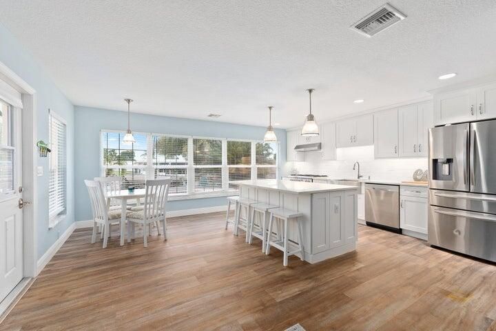 Dining room, Interior, Kitchen, Pendant Lights, Recessed Lighting, Stainless Steel Appliances, Wood Texture Flooring