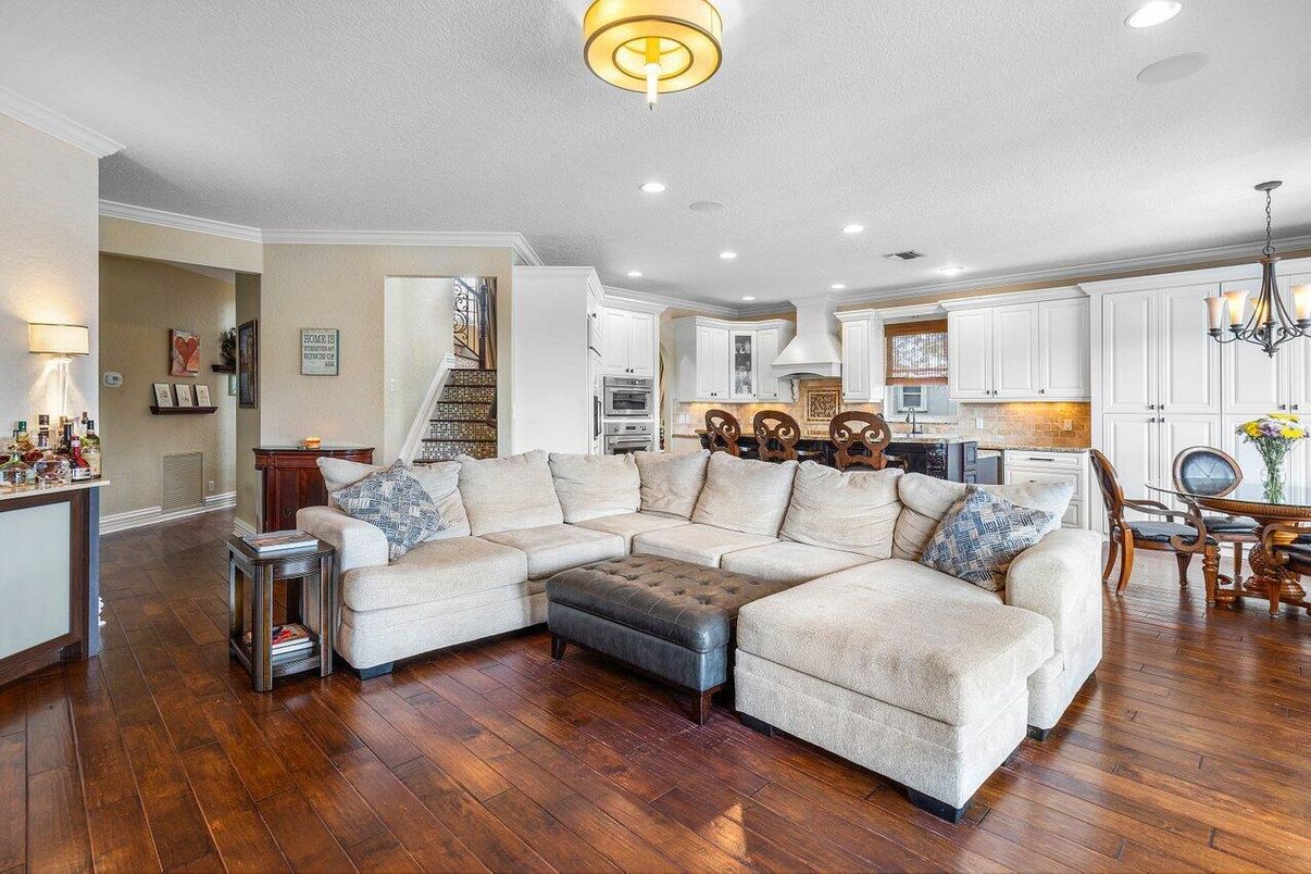 Chandelier, Dining room, Interior, Kitchen, Living room, Pendant Lights, Recessed Lighting, Stainless Steel Appliances, Wood Texture Flooring