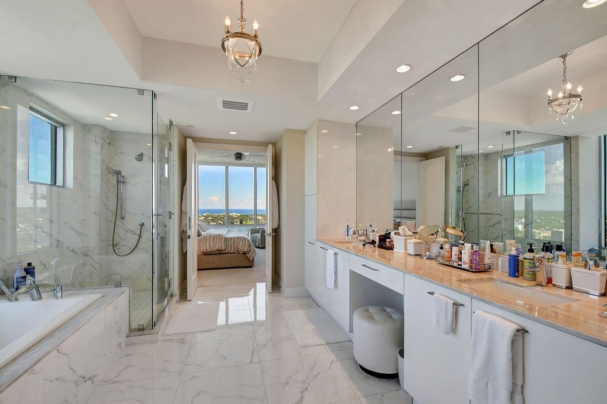 Bathroom, Chandelier, Dual Sink Vanities, Glass Shower, Interior, Marble, Marble Walls, Pendant Lights, Recessed Lighting, Water