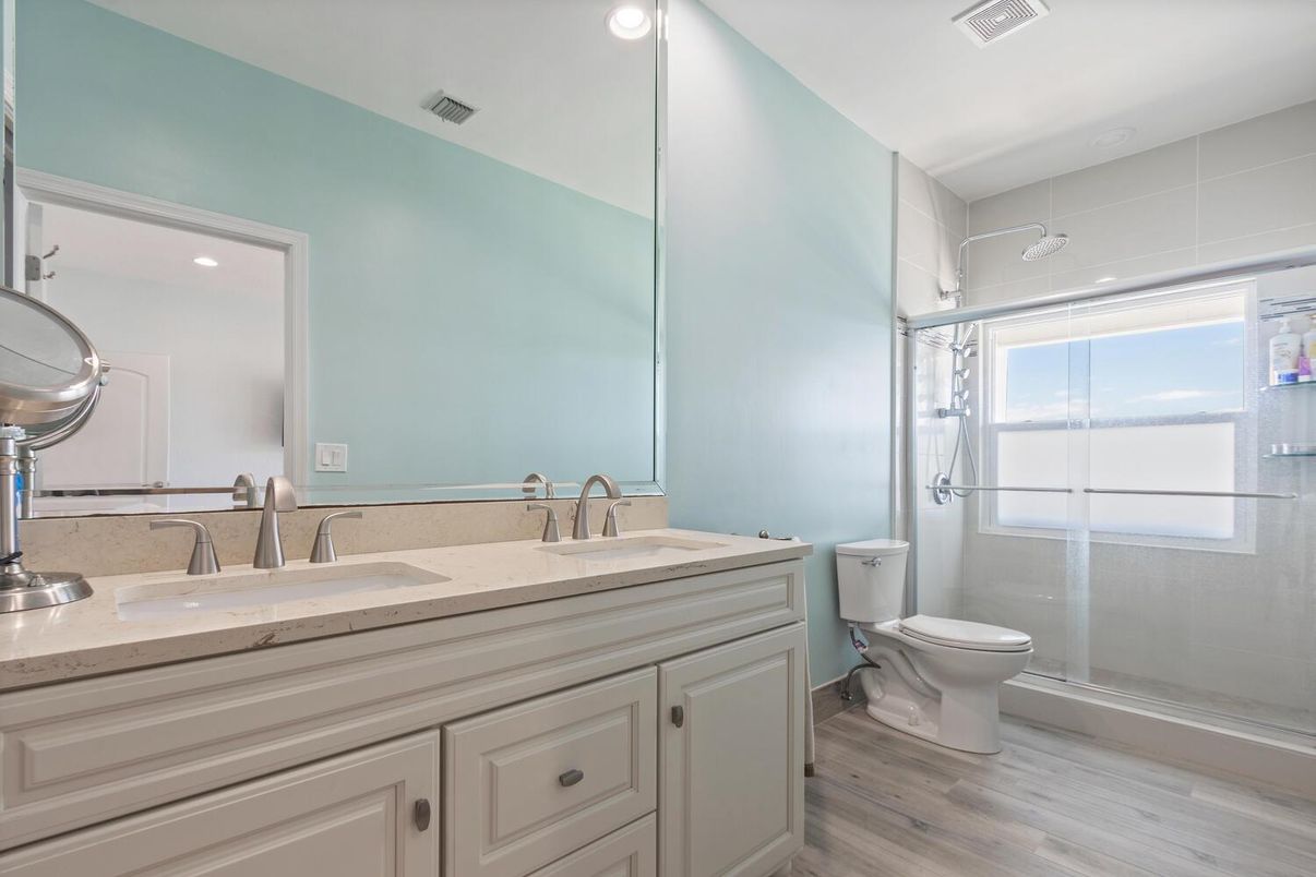 Bathroom, Dual Sink Vanities, Glass Shower, Interior, Recessed Lighting, Wood Texture Flooring