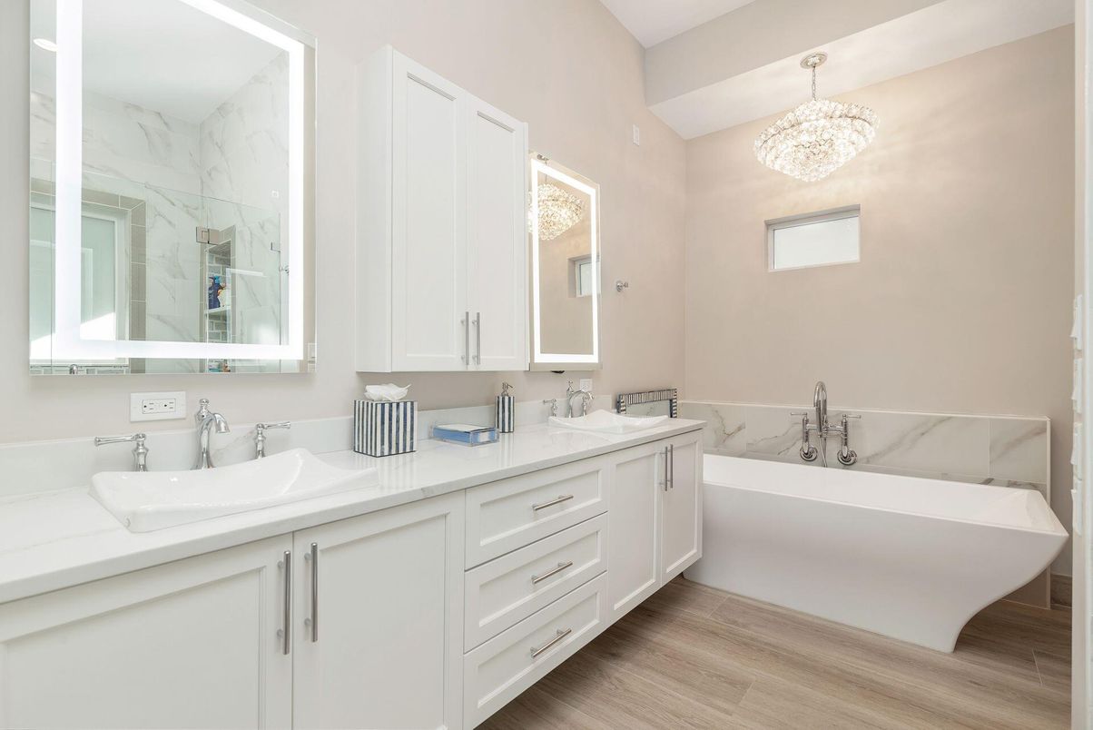 Bathroom, Chandelier, Dual Sink Vanities, Free Standing Baths, Interior, Marble Walls, Wood Texture Flooring