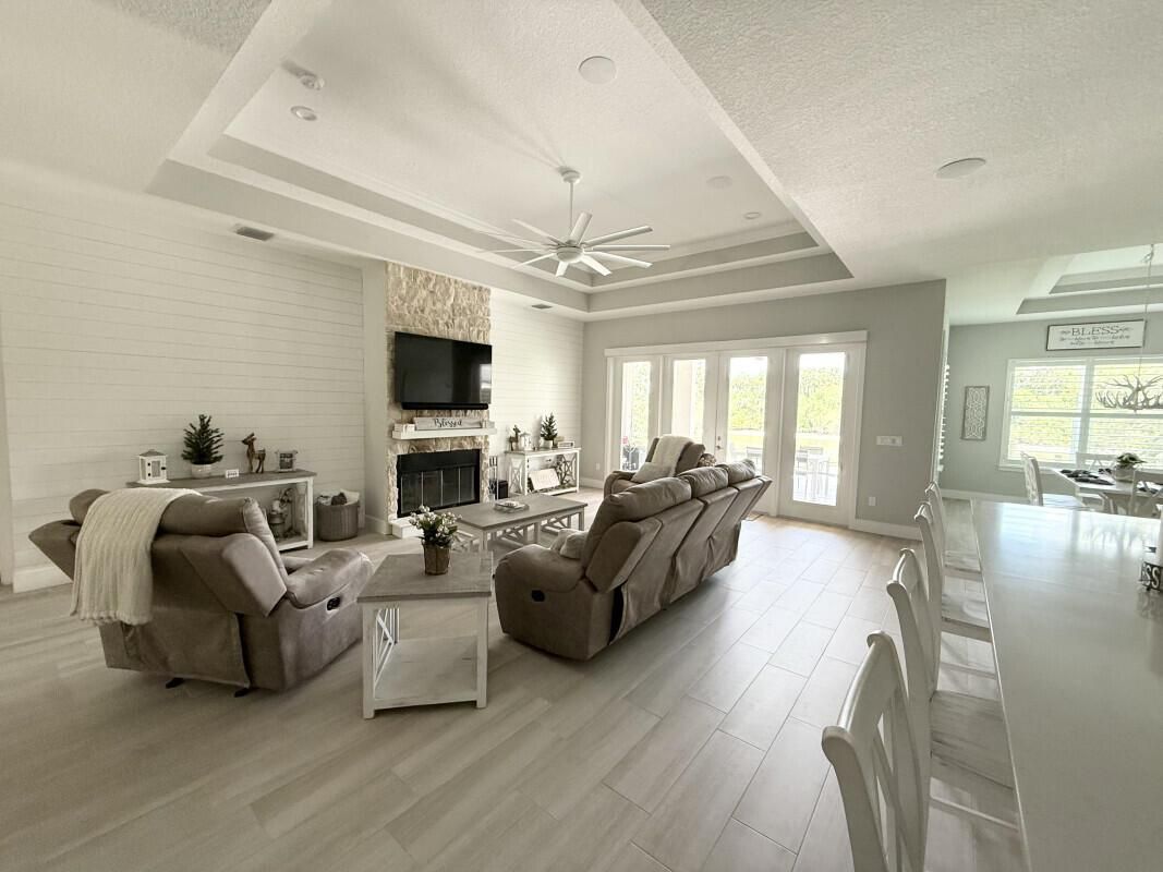 Dining room, Fireplace, Interior, Living room, Recessed Lighting, Wood Texture Flooring