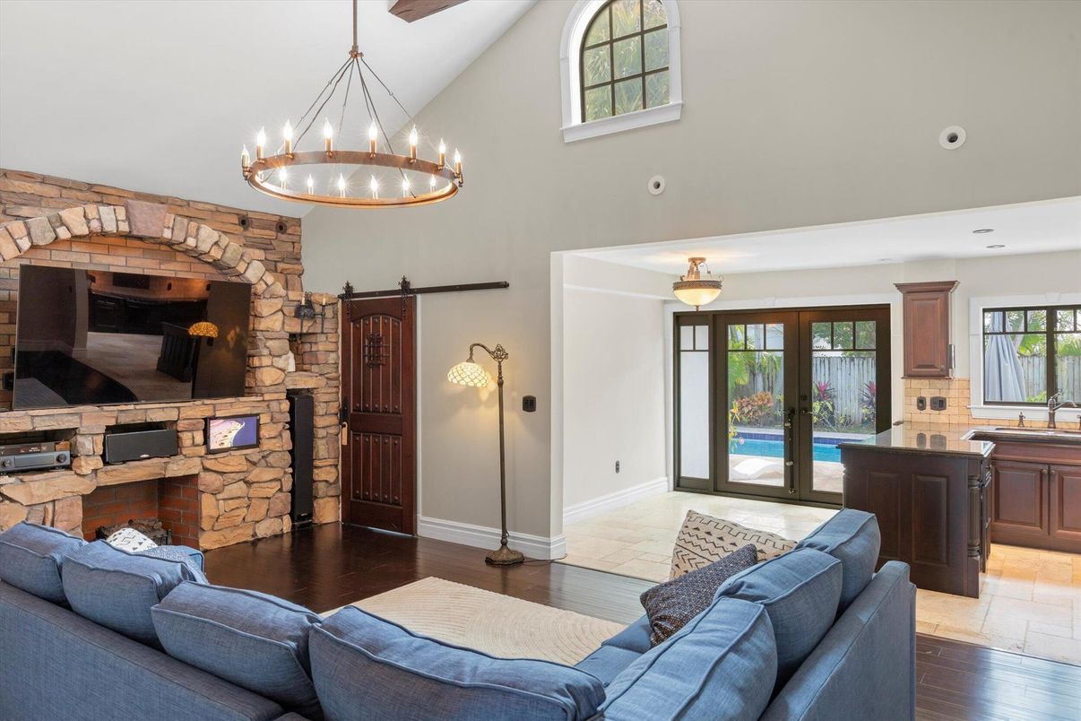 Chandelier, Fireplace, Interior, Living room, Pendant Lights, Recessed Lighting, Stone Walls, Wood Texture Flooring