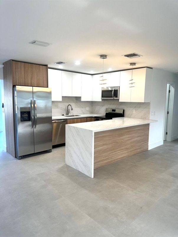 Interior, Kitchen, Marble Walls, Pendant Lights, Recessed Lighting, Stainless Steel Appliances