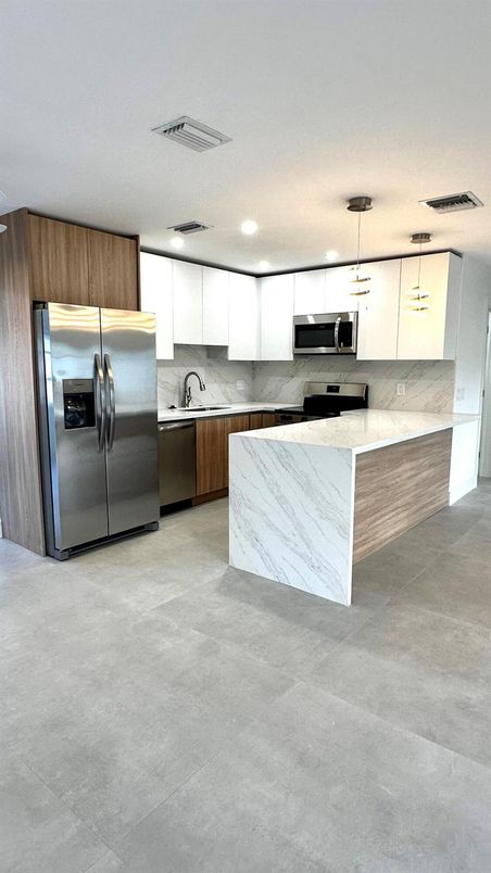 Interior, Kitchen, Marble Walls, Pendant Lights, Recessed Lighting, Stainless Steel Appliances