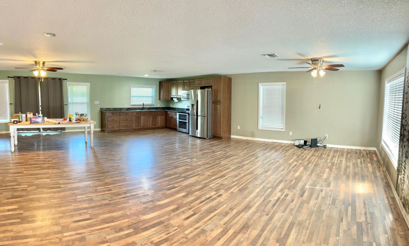 Empty room, Interior, Kitchen, Recessed Lighting, Stainless Steel Appliances, Wood Texture Flooring