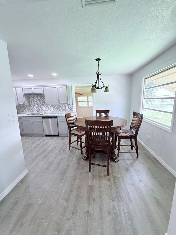 Dining room, Interior, Kitchen, Pendant Lights, Recessed Lighting, Stainless Steel Appliances, Wood Texture Flooring