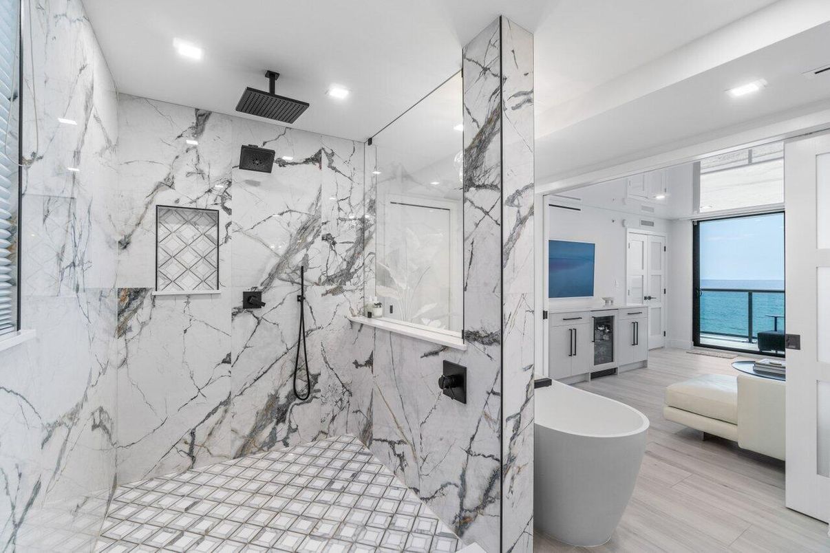 Bathroom, Free Standing Baths, Glass Shower, Interior, Marble Walls, Recessed Lighting, Water, Wood Texture Flooring