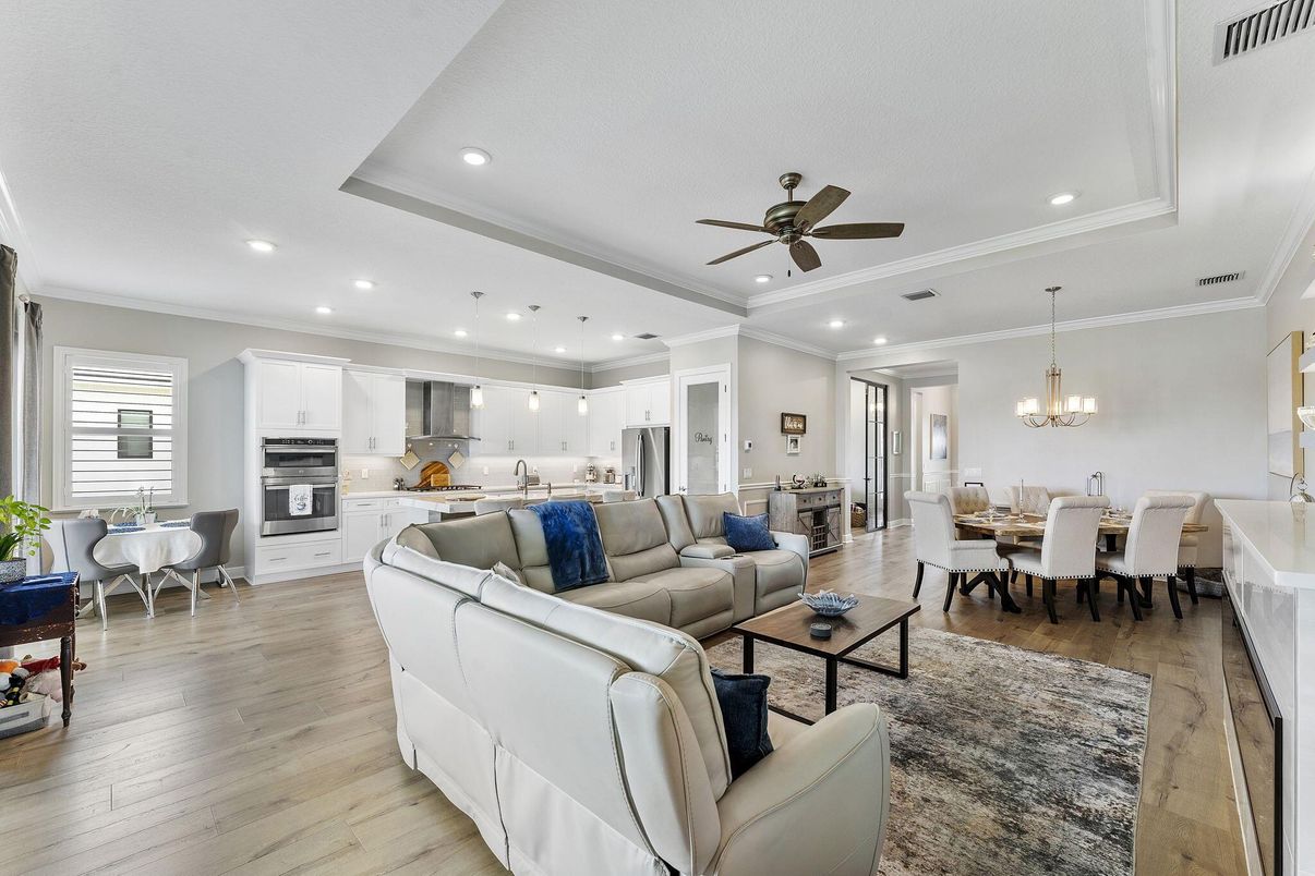 Chandelier, Dining room, Interior, Kitchen, Living room, Pendant Lights, Recessed Lighting, Stainless Steel Appliances, Wood Texture Flooring