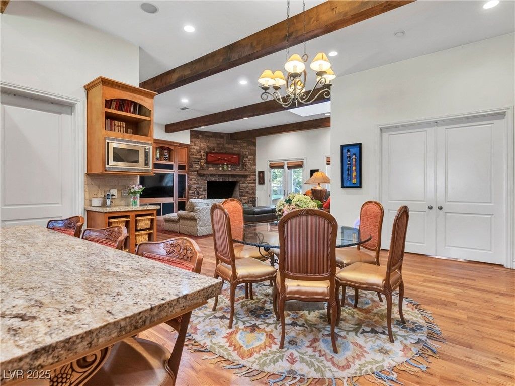 Chandelier, Dining room, Fireplace, Interior, Recessed Lighting, Stone Walls, Wooden Beams, Wood Texture Flooring