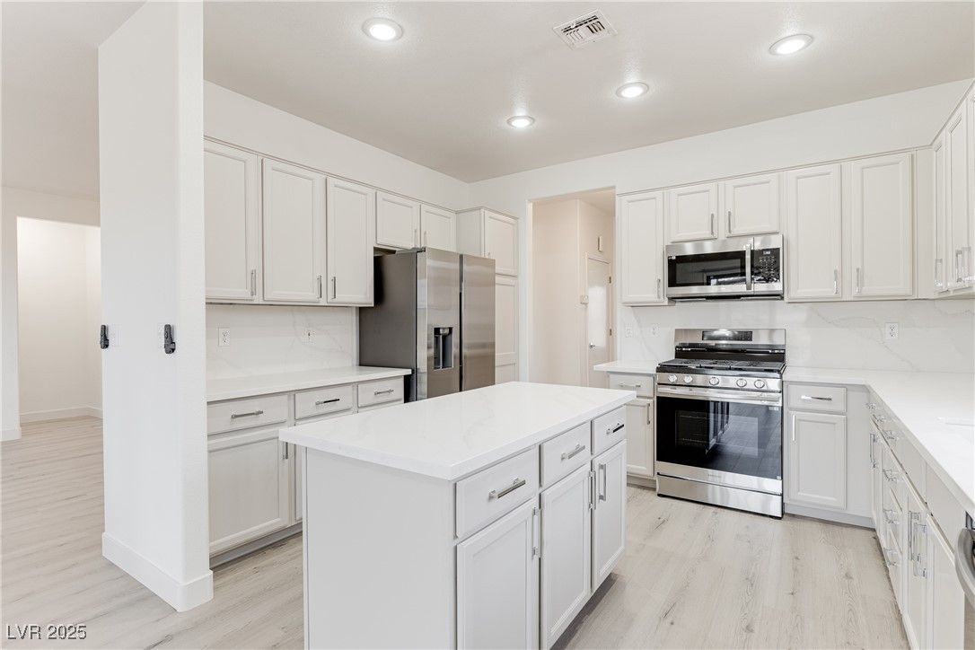 Interior, Kitchen, Marble Walls, Recessed Lighting, Stainless Steel Appliances, Wood Texture Flooring