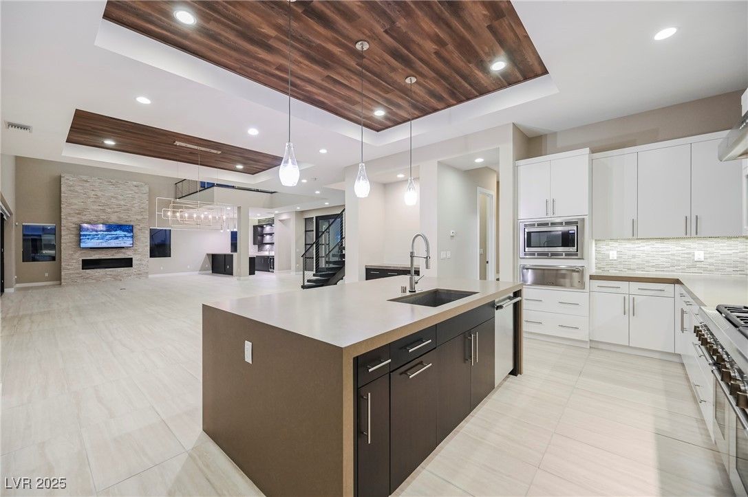 Fireplace, Interior, Kitchen, Pendant Lights, Recessed Lighting, Stainless Steel Appliances, Stone Walls, Wooden Ceilings
