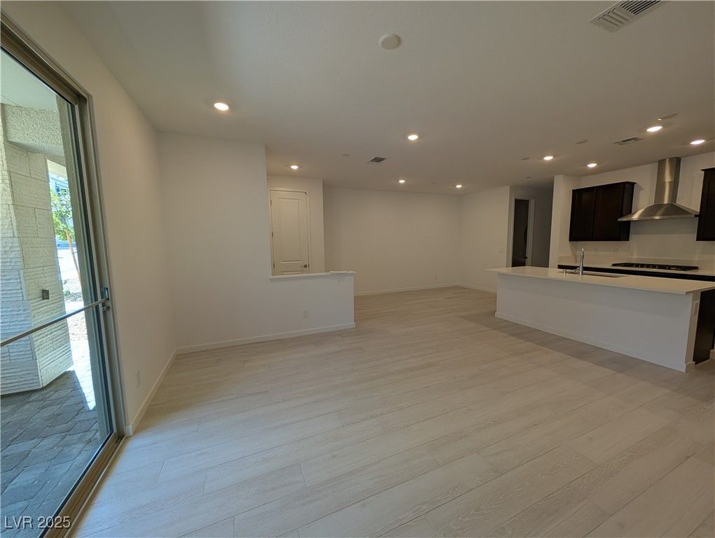 Empty room, Interior, Kitchen, Recessed Lighting, Stainless Steel Appliances, Wood Texture Flooring