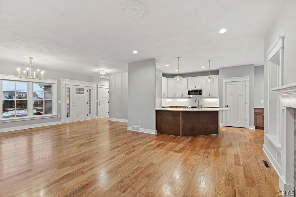 Chandelier, Fireplace, Interior, Kitchen, Pendant Lights, Recessed Lighting, Stainless Steel Appliances, Wood Texture Flooring