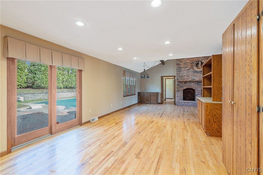 Empty room, Fireplace, Interior, Recessed Lighting, Stone Walls, Wood Texture Flooring