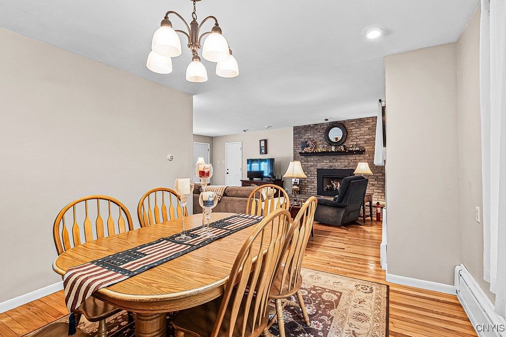 Dining room, Fireplace, Interior, Living room, Recessed Lighting, Stone Walls, Wood Texture Flooring