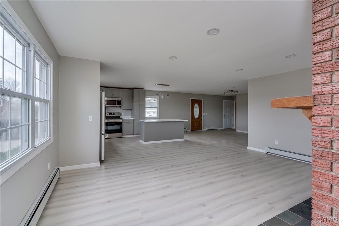 Empty room, Interior, Kitchen, Pendant Lights, Recessed Lighting, Stainless Steel Appliances, Wood Texture Flooring