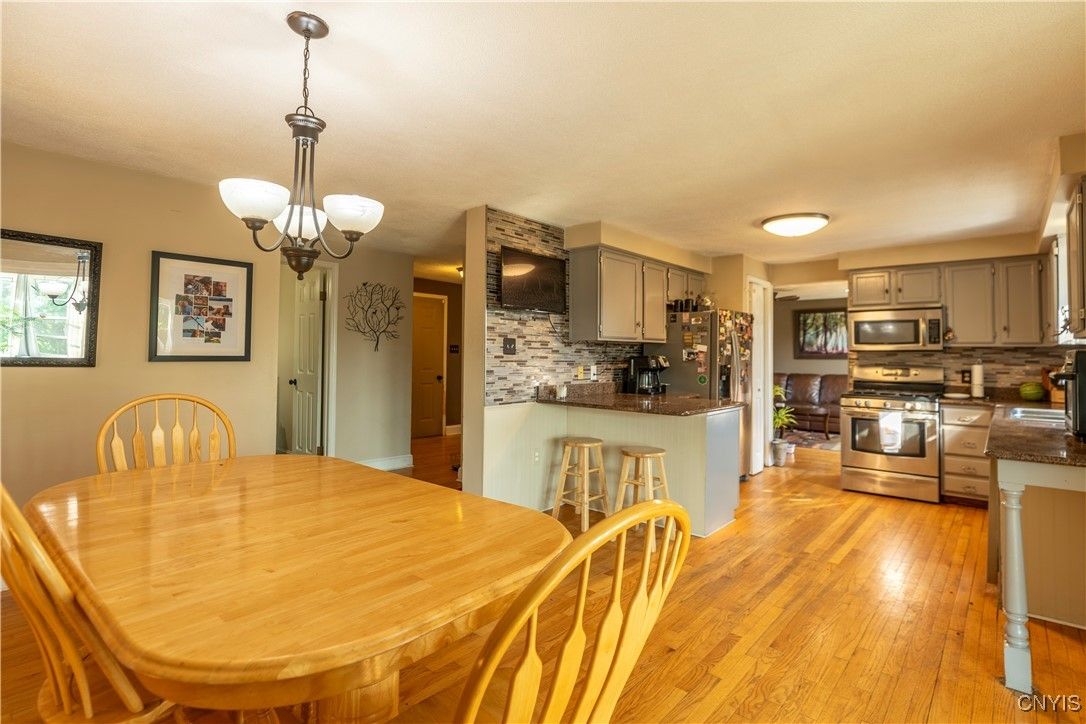 Chandelier, Dining room, Interior, Kitchen, Pendant Lights, Stainless Steel Appliances, Wood Texture Flooring