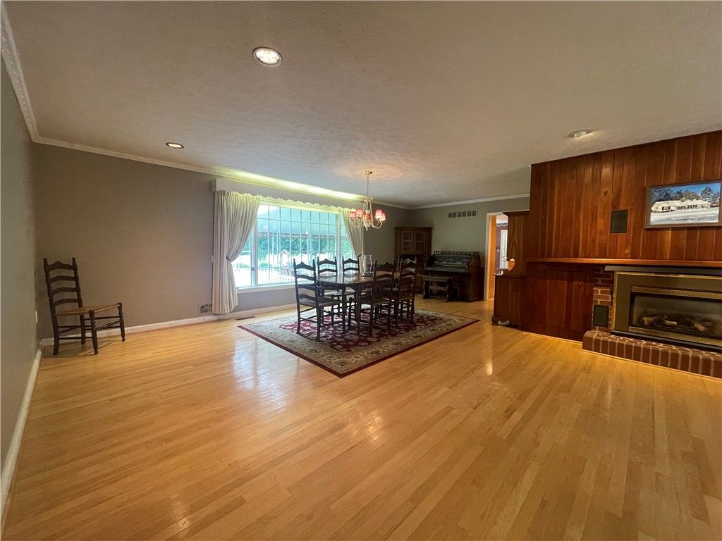 Chandelier, Dining room, Fireplace, Interior, Recessed Lighting, Wood Texture Flooring, Wooden Walls