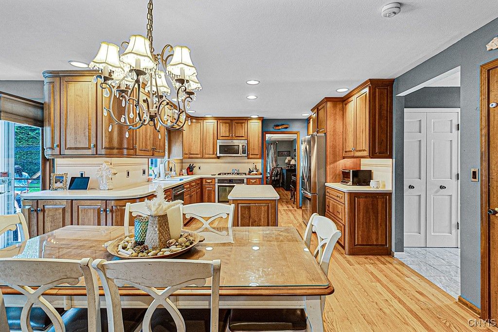 Chandelier, Dining room, Interior, Kitchen, Recessed Lighting, Stainless Steel Appliances, Wood Texture Flooring