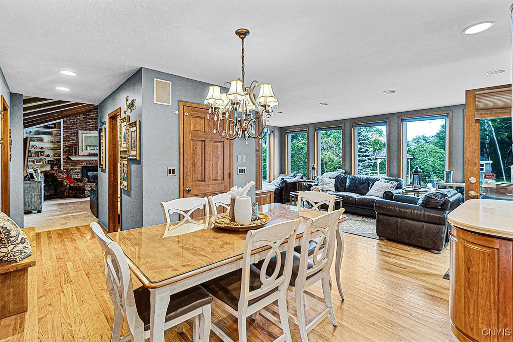 Chandelier, Dining room, Fireplace, Interior, Living room, Recessed Lighting, Stone Walls, Wood Texture Flooring