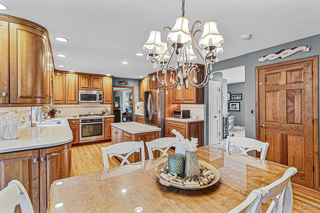 Chandelier, Dining room, Interior, Kitchen, Recessed Lighting, Stainless Steel Appliances, Wood Texture Flooring