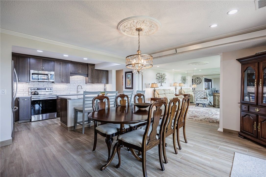 Chandelier, Dining room, Interior, Kitchen, Living room, Recessed Lighting, Stainless Steel Appliances, Wood Texture Flooring