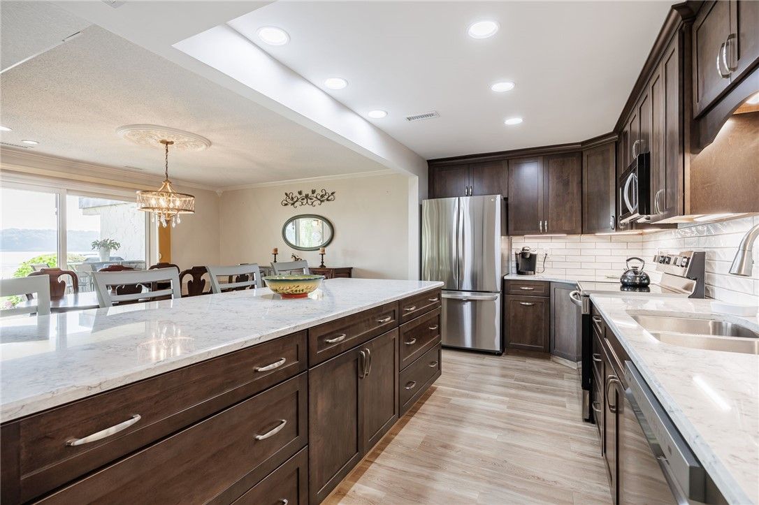 Chandelier, Dining room, Interior, Kitchen, Pendant Lights, Recessed Lighting, Stainless Steel Appliances, Wood Texture Flooring