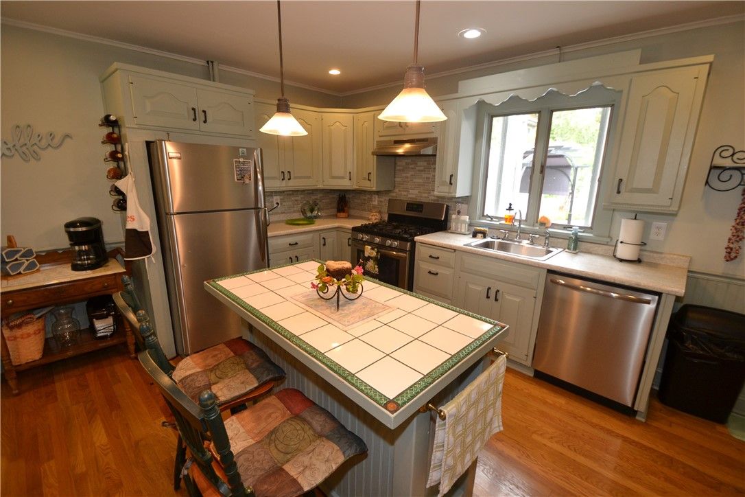 Interior, Kitchen, Pendant Lights, Recessed Lighting, Stainless Steel Appliances, Tile Countertops, Wood Texture Flooring