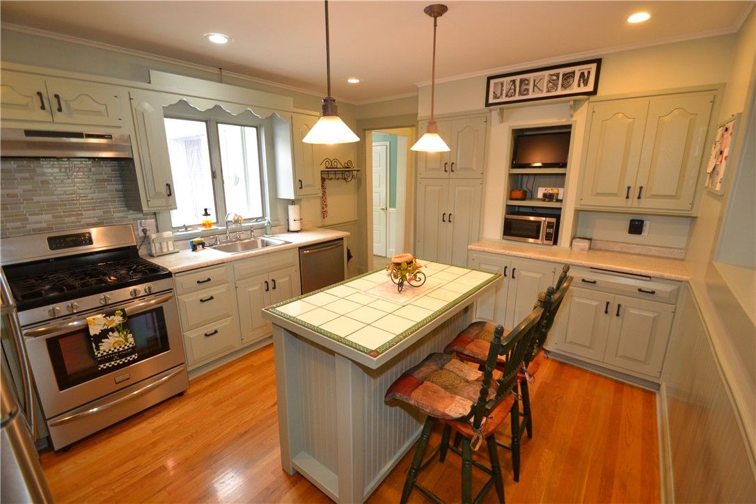 Interior, Kitchen, Pendant Lights, Recessed Lighting, Stainless Steel Appliances, Tile Countertops, Wood Texture Flooring