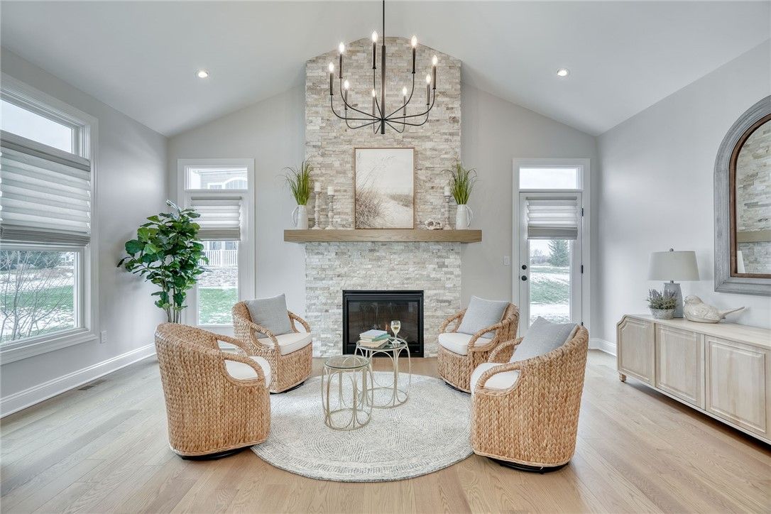 Chandelier, Fireplace, Interior, Living room, Recessed Lighting, Stone Walls, Wood Texture Flooring