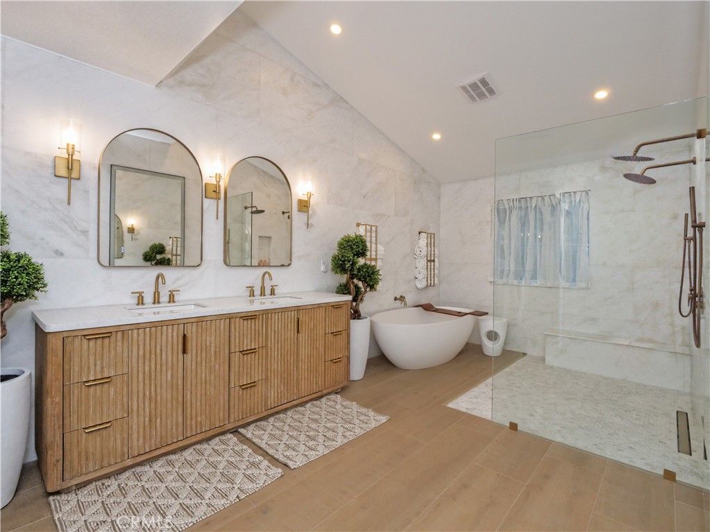 Bathroom, Dual Sink Vanities, Free Standing Baths, Glass Shower, Interior, Marble Walls, Recessed Lighting, Wood Texture Flooring