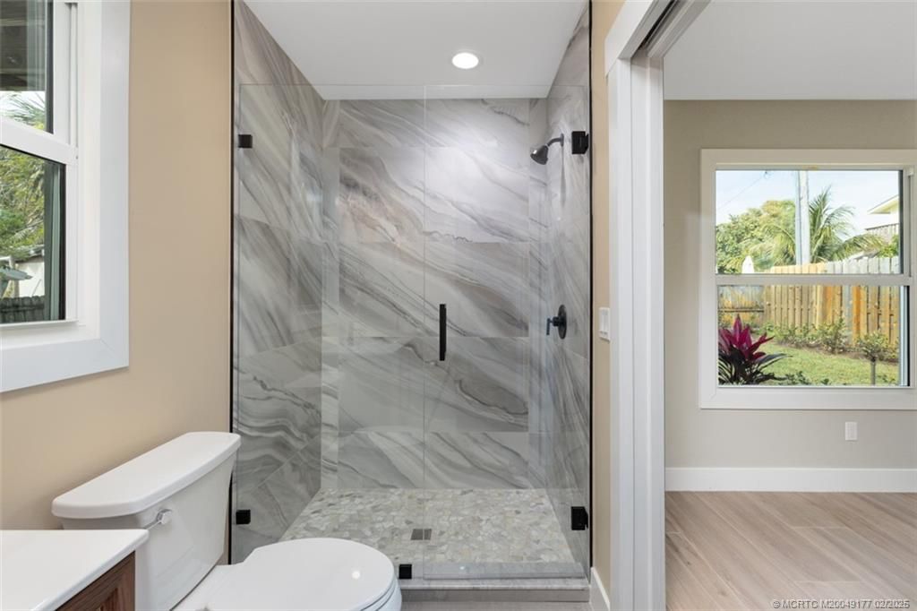 Bathroom, Glass Shower, Interior, Marble Walls, Recessed Lighting, Wood Texture Flooring