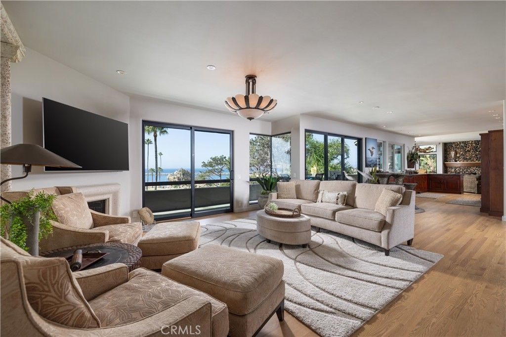 Chandelier, Fireplace, Interior, Living room, Pendant Lights, Recessed Lighting, Water, Wood Texture Flooring